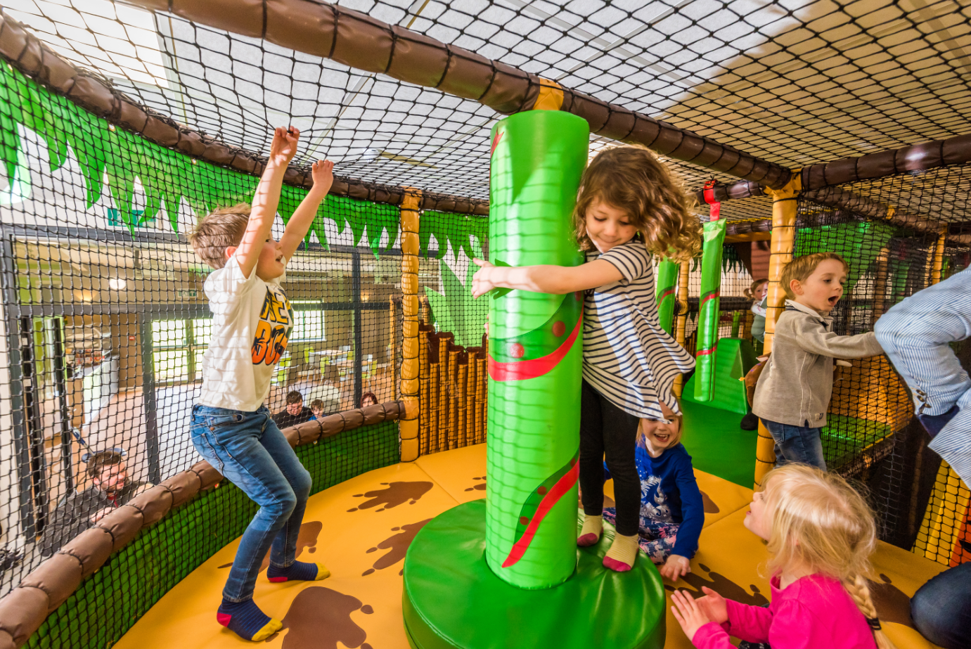 Children playing on spinner in Leo's Funzone