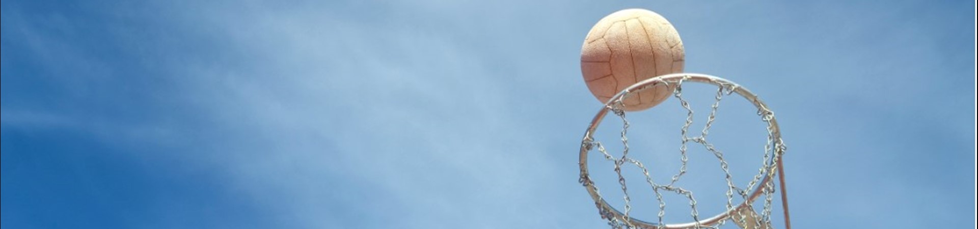 Netball going into a netball hoop