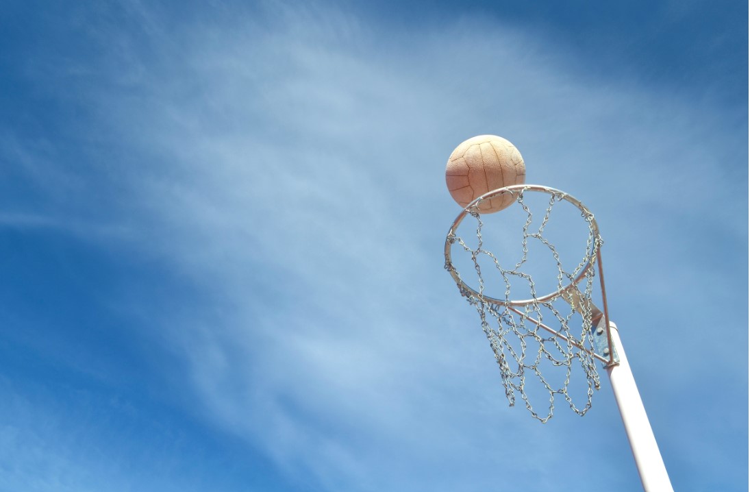 Netball going into a netball hoop