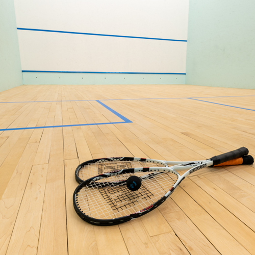 Squash rackets and ball on the floor of the squash court at One Leisure Huntingdon